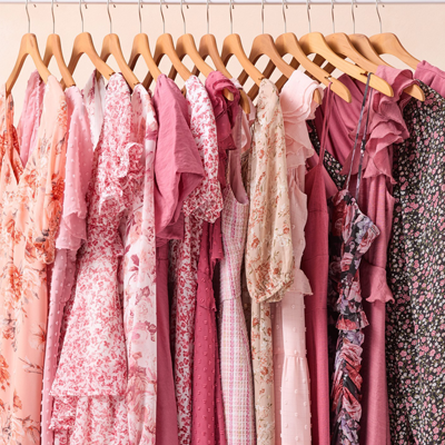 A row of dresses hung up by hangers