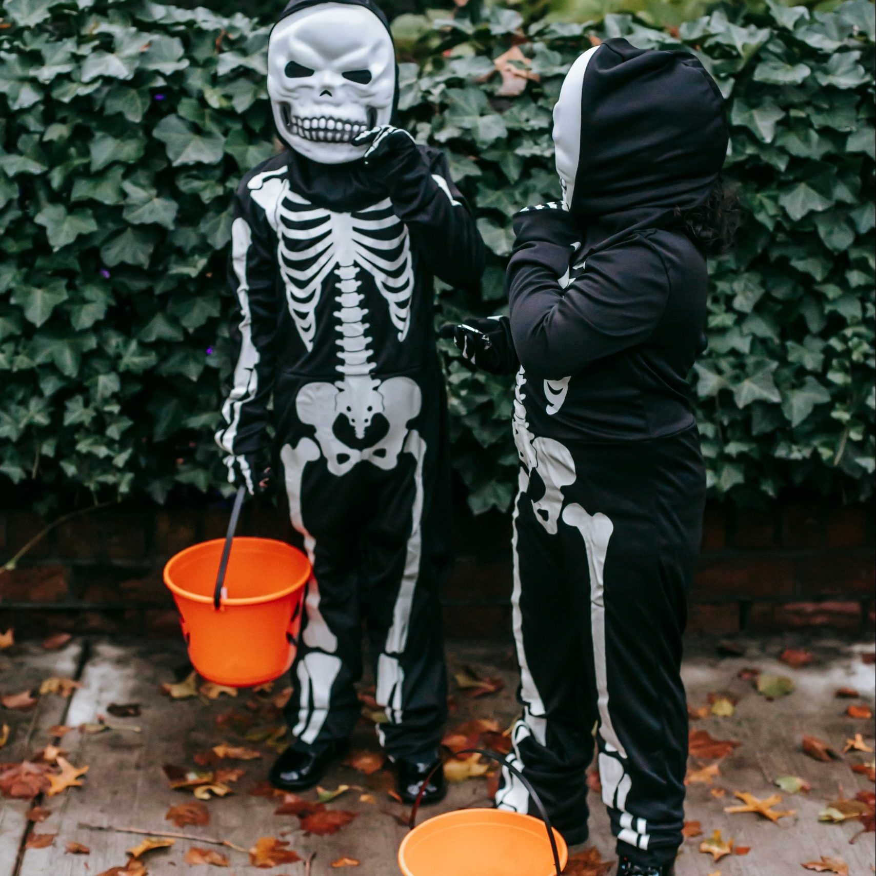 two children dressed up in costumes of skeletons