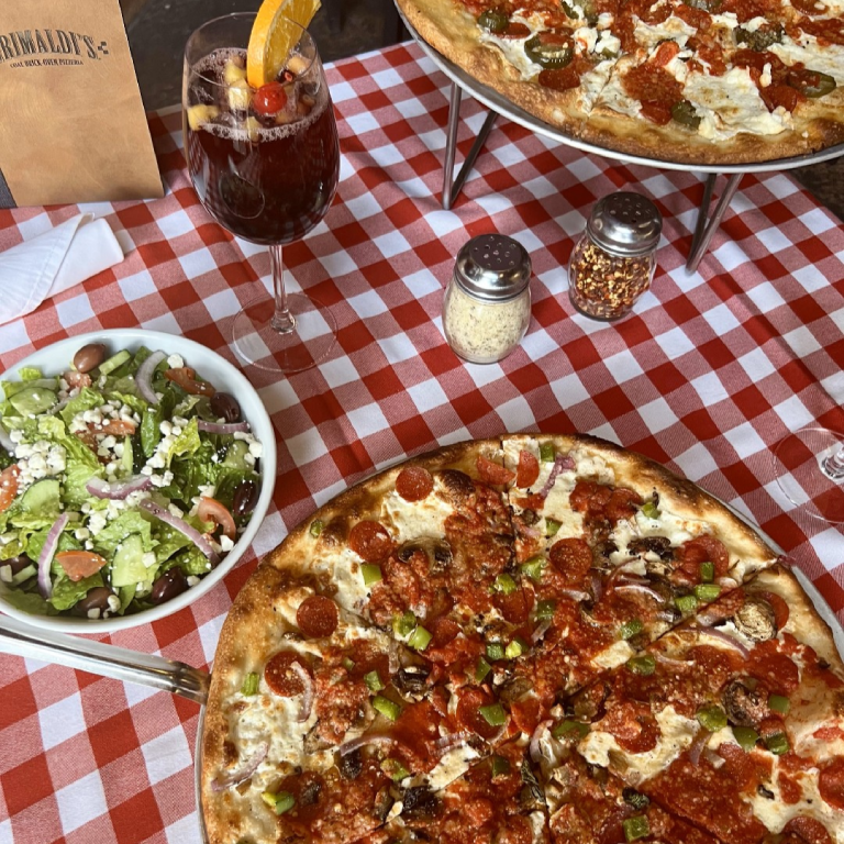 Grimaldi's Pizzeria pizzas and side salad with wine